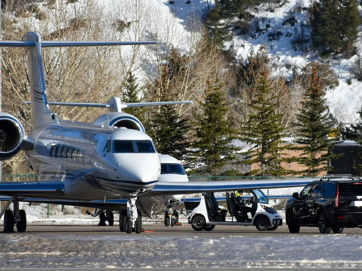 Business jets parked on a snowy mountain ramp